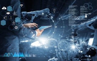 An employee of a manufacturing firm uses a robotic arm and tablet with support from IT Services In New York.